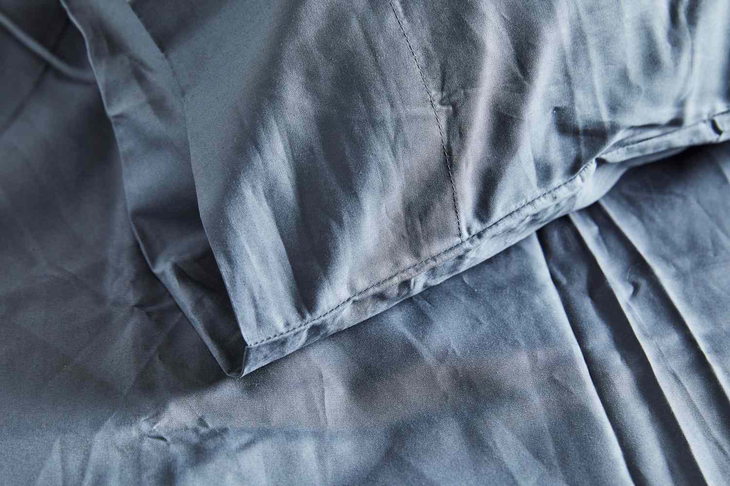 A close-up of the pillowcase stitching of the Sijo Home Organic Percale Cotton CrispCool Cotton Sheet Set