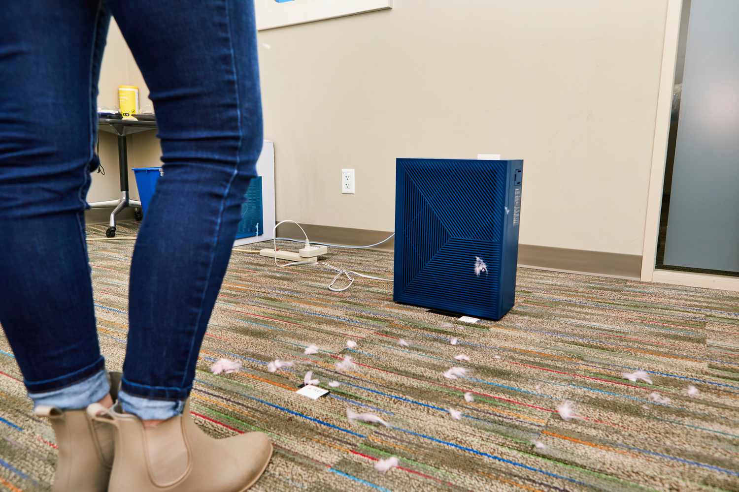 The Coway Airmega 160 Air Purifier on the floor surrounded with uzz