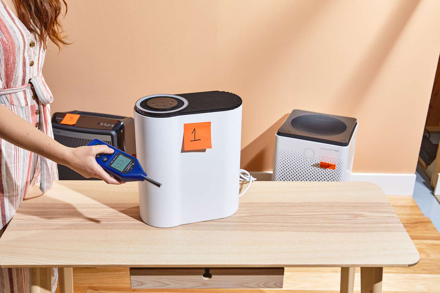 Person taking a reading from the Aroeve MK04 Air Purifier