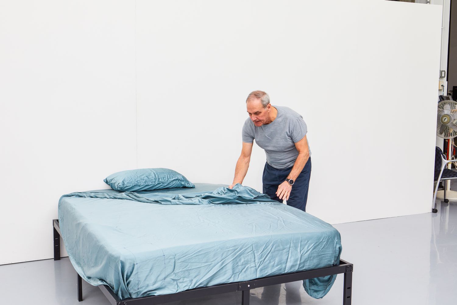 Person making a bed with the Colorado Home Co. Mulberry Silk Bed Sheets Set