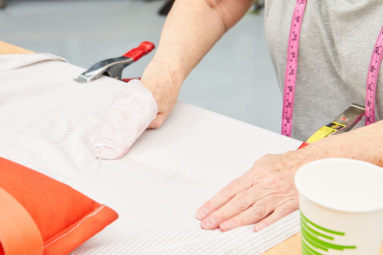 Person rubbing The Citizenry Organic Resort Cotton Sheet Set on a table 